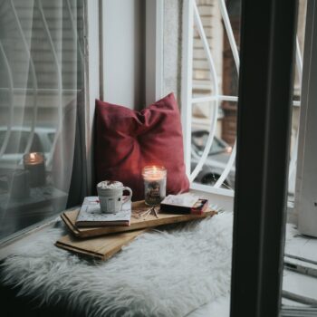 photo of gel candle on board beside pillow