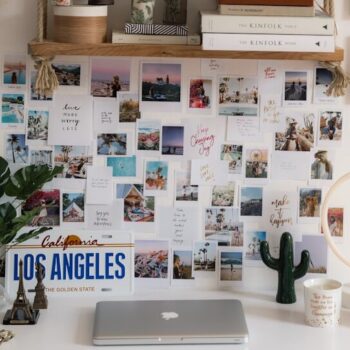 a white desk topped with pictures and hats