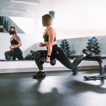 woman in black sports bra and black leggings doing exercise