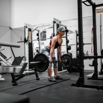 man in orange tank top and black shorts doing exercise