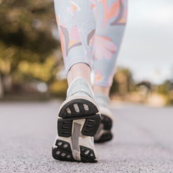 person wearing black and white nike shoes