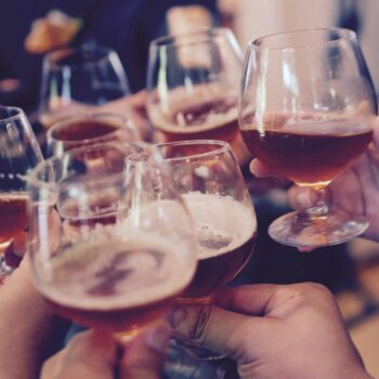 people holding snifter glasses