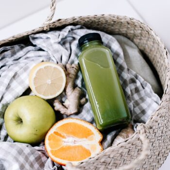 green disposable lighter beside orange fruit on brown woven basket
