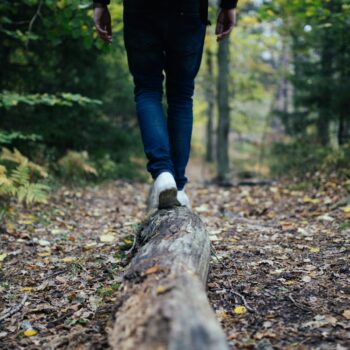 man walking on forest