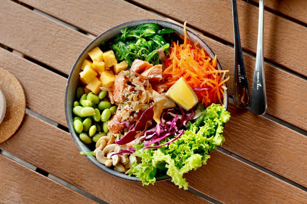 a bowl of food sitting on a wooden table