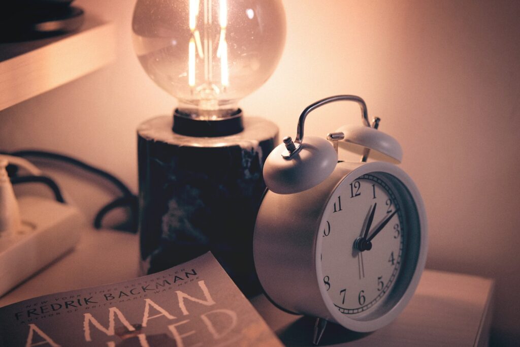 a clock and a lamp on a table