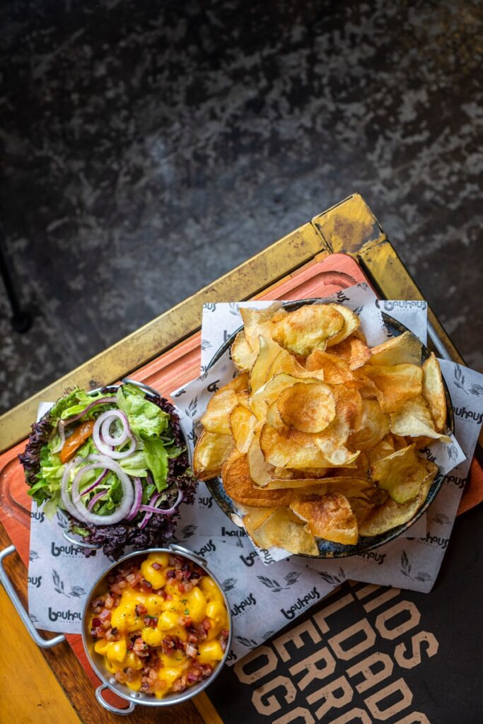 a tray with a bowl of chips, a bowl of salsa and a bowl of